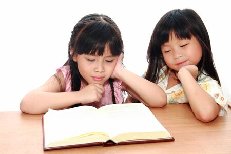 serious little girl  reading a bookの写真素材
