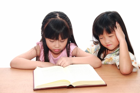 serious little girl  reading a bookの写真素材