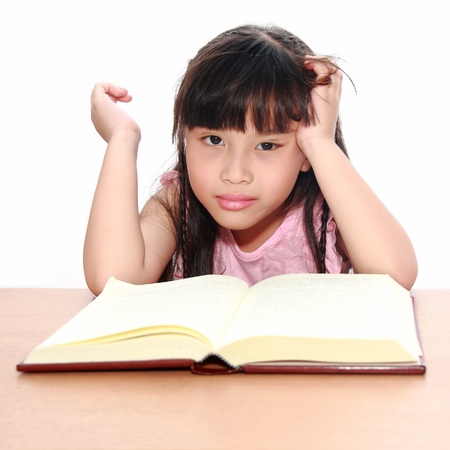 serious little girl  reading a bookの写真素材