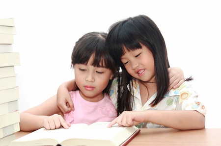 Intelligent little girl  reading a bookの写真素材