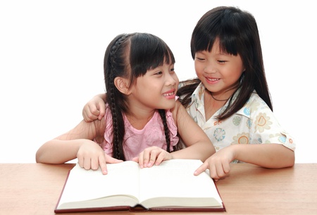 Intelligent little girl  reading a bookの写真素材