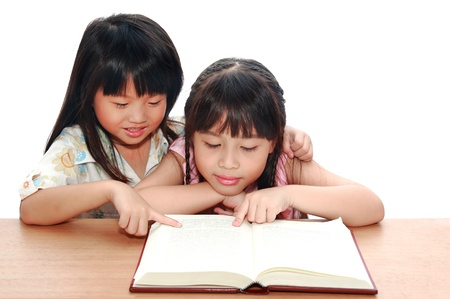 Intelligent little girl  reading a bookの写真素材