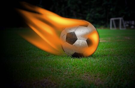 Football burning on green grassの写真素材