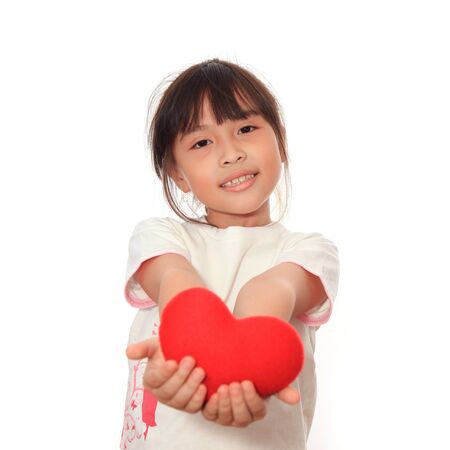 Asian cute girl giving symbol of red heart for you.の写真素材