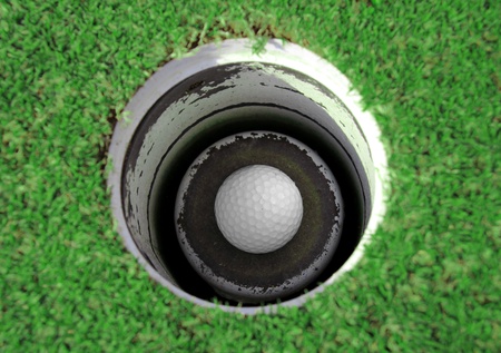 Golf ball in the holeの写真素材