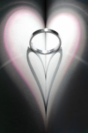 Ring casting a heart shaped shadow.の写真素材