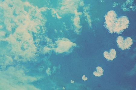 grunge heart clouds on the sky old paper backgroundの写真素材