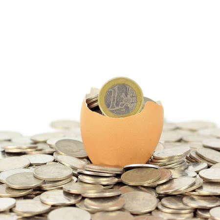 Broken eggshell on coinsの写真素材
