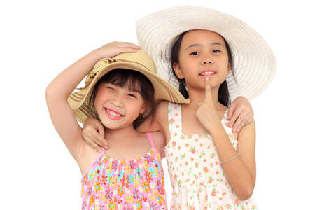 Two beautiful happy little asian girl with strawの写真素材