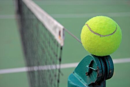 Tennis ball on a tennis courtの写真素材
