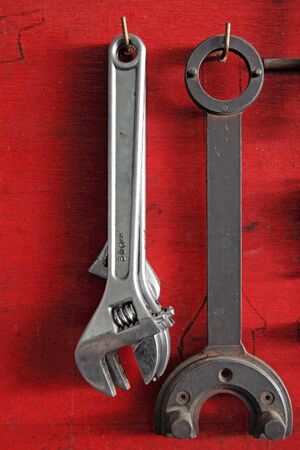 Vintage tools on wooden red wall