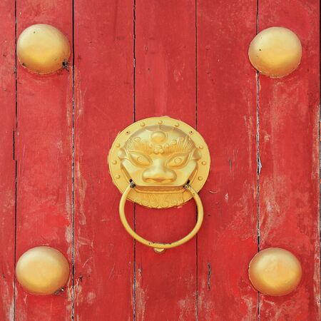 Golden Dragon knock on old red wooden doorの写真素材