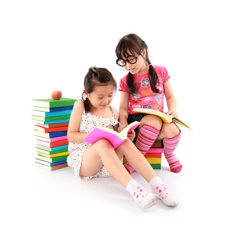 Two student little asian girl reading the bookの写真素材
