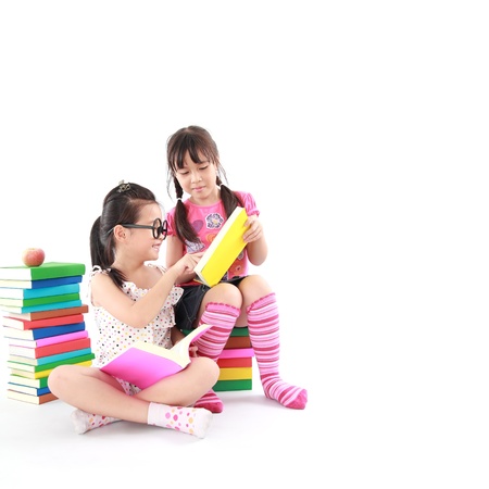 student little asian girl reading the bookの写真素材