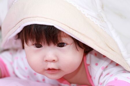 baby girl on the bedの写真素材