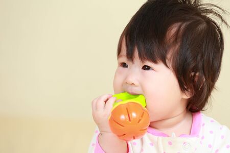 baby girl on the bedの写真素材