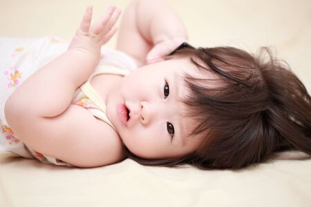 Asian baby girl on the bedの写真素材