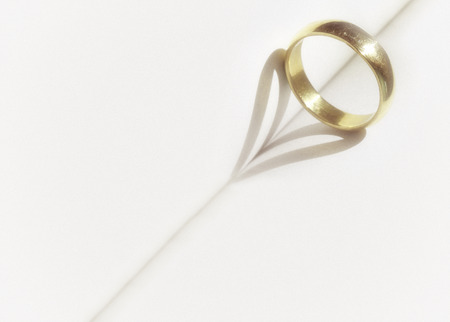heart shadow with rings on a book middle write your text in white space with grain vintageの写真素材