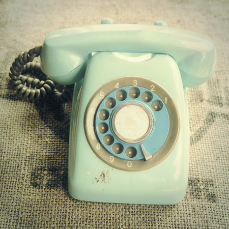Retro rotary telephone on natural linen textureの写真素材