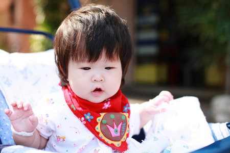 Happy baby girl in Strollerの写真素材