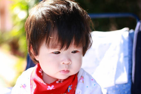 Happy baby girl in Strollerの写真素材