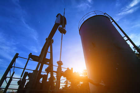 Oil pump or oil energy industrial machine for petroleum in the sunsetの写真素材