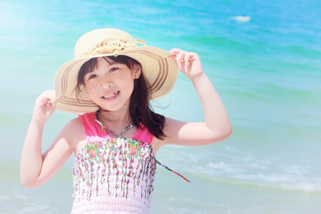 Happy Smiling little girl on beach vintage film styleの写真素材