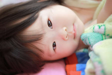 Little girl on the bedの写真素材
