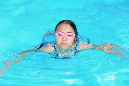 Happy girl in the poolの写真素材
