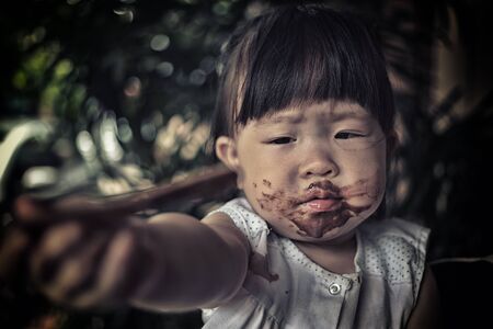 poor children eating ice creamの写真素材