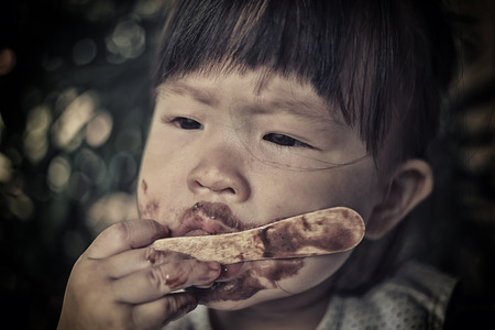 poor children eating ice creamの写真素材