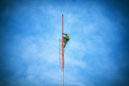 Repairman working on communications towerの写真素材