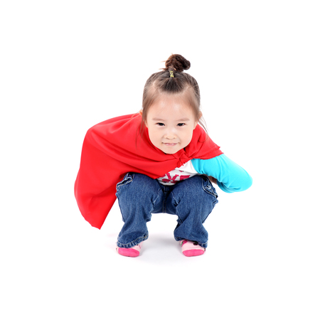 Superhero little asian girl in a red raincoat on white backgroundの写真素材