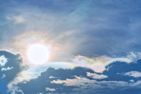 iridescent pileus cloud rainbow clouds background with airplaneの写真素材