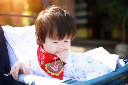 portrait of a baby girl in safety seat