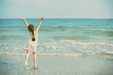 Happy little girl on the beach retro styleの写真素材