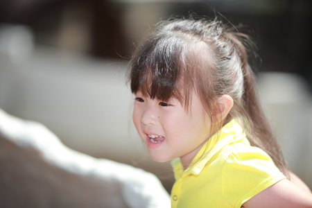 Happy cute little girl outdoors in summer dayの写真素材
