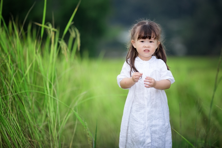 Happy cute little girl outdoors in summer dayの写真素材