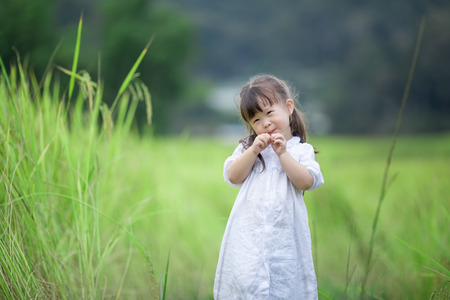 Happy cute little girl outdoors in summer dayの写真素材
