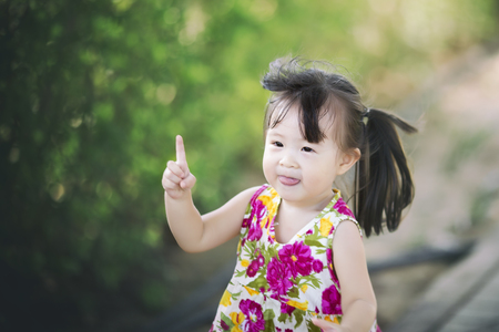 Little girl running in play park in summer timeの写真素材
