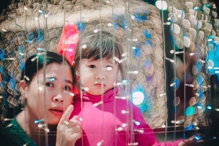 Little girl with led lights background in christmas and new year conceptの写真素材