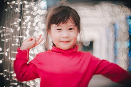 Little girl with led lights background in christmas and new year conceptの写真素材