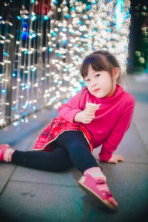 Little girl with led lights background in christmas and new year conceptの写真素材