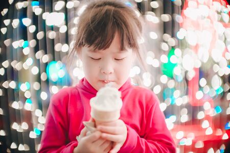 Little girl with led lights background in christmas and new year conceptの写真素材