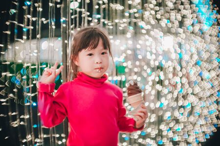 Little girl with led lights background in christmas and new year conceptの写真素材