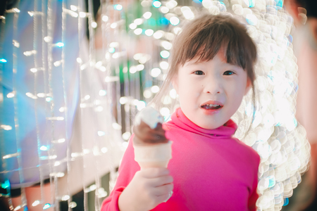 Little girl with led lights background in christmas and new year conceptの写真素材