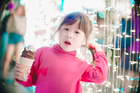 Little girl with led lights background in christmas and new year conceptの写真素材