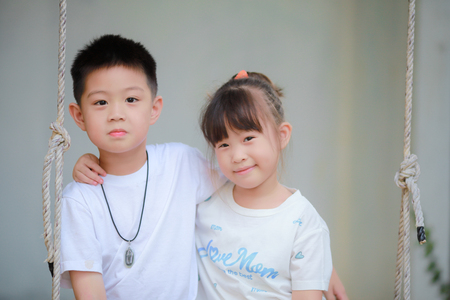 brother and sister on swingの写真素材