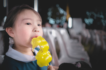children girl with candy in her handの写真素材