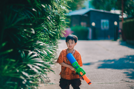 Children playing  Water gun  in Water Festival  Chiang mai Thailandの写真素材